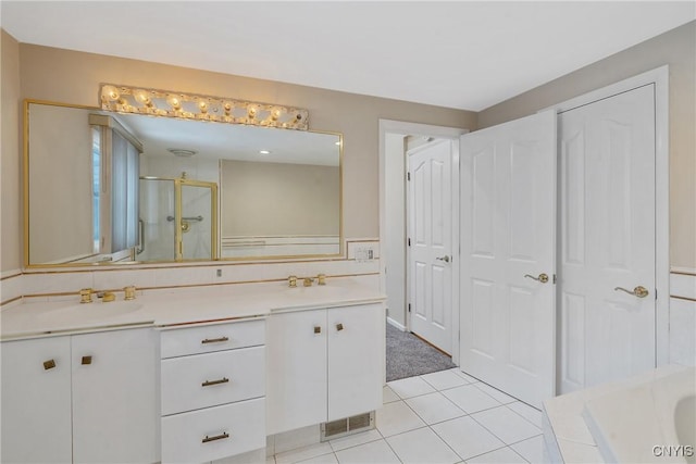 bathroom featuring tile patterned flooring, shower with separate bathtub, and vanity