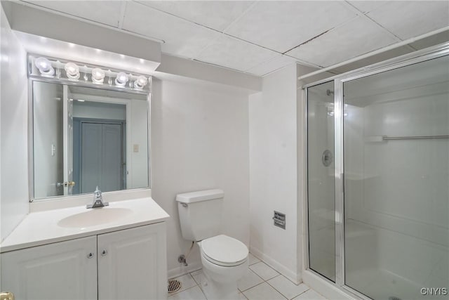 bathroom with vanity, toilet, tile patterned flooring, and a shower with door