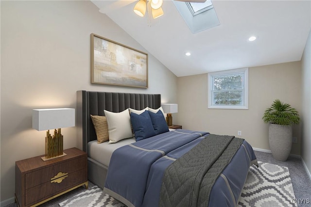 bedroom featuring lofted ceiling with skylight, ceiling fan, and carpet