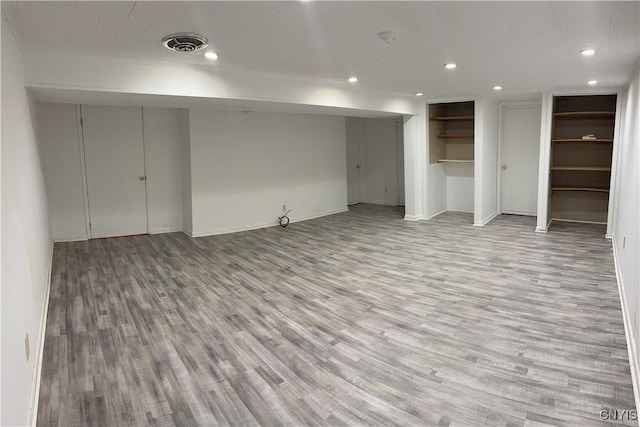 basement with hardwood / wood-style flooring