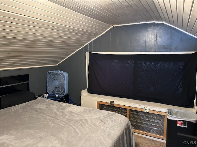 unfurnished bedroom with lofted ceiling, wooden ceiling, and wood walls