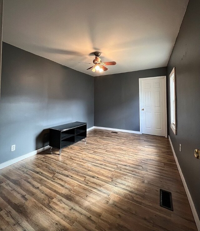 unfurnished room with hardwood / wood-style flooring and ceiling fan