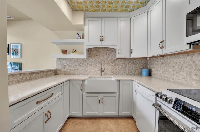 kitchen featuring sink, white cabinets, white appliances, and decorative backsplash