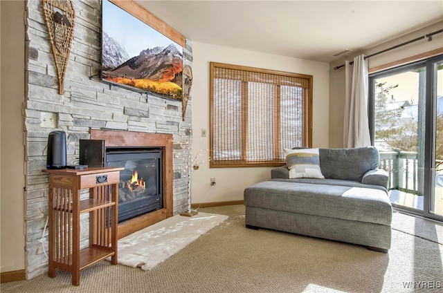 living area with a fireplace and carpet