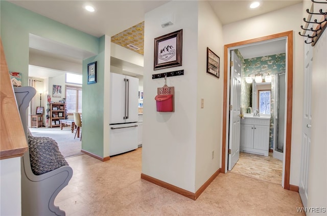 hallway featuring plenty of natural light and sink