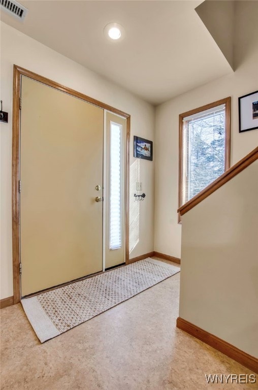 entrance foyer with light carpet