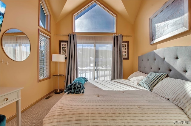 carpeted bedroom featuring lofted ceiling and access to exterior