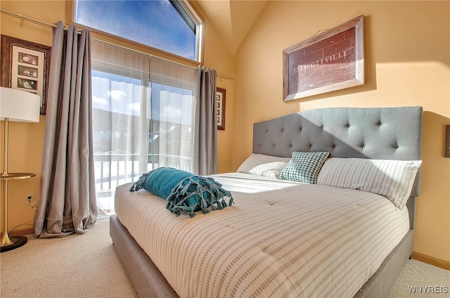 carpeted bedroom featuring multiple windows, vaulted ceiling, and access to outside