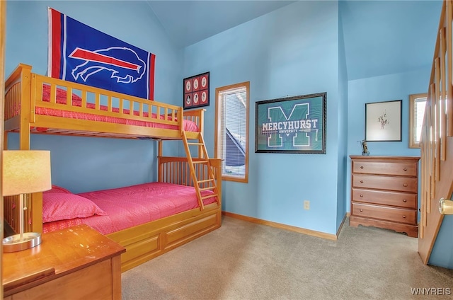 carpeted bedroom featuring vaulted ceiling