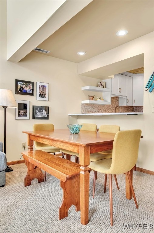 dining space with light carpet