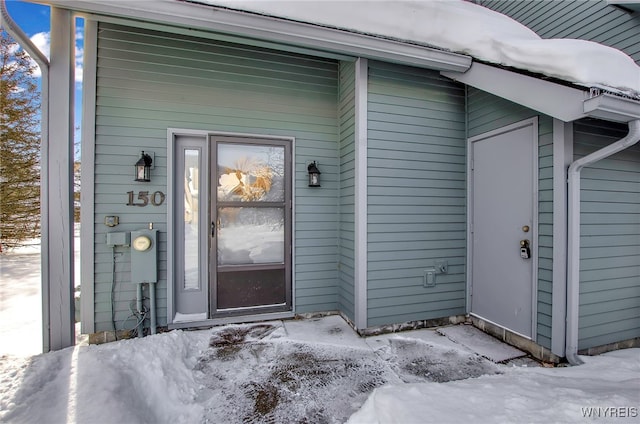 view of snow covered property entrance