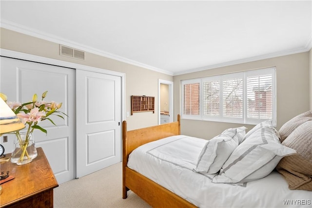 bedroom with crown molding, light colored carpet, and a closet