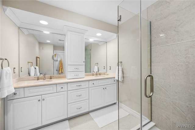 bathroom featuring vanity, a shower with shower door, and tile patterned floors