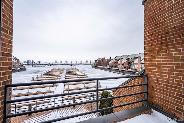 view of snow covered back of property