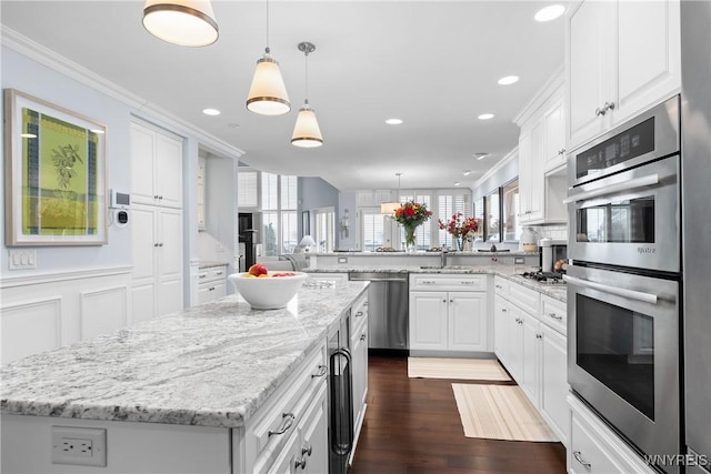 kitchen with white cabinetry, a kitchen island, and appliances with stainless steel finishes