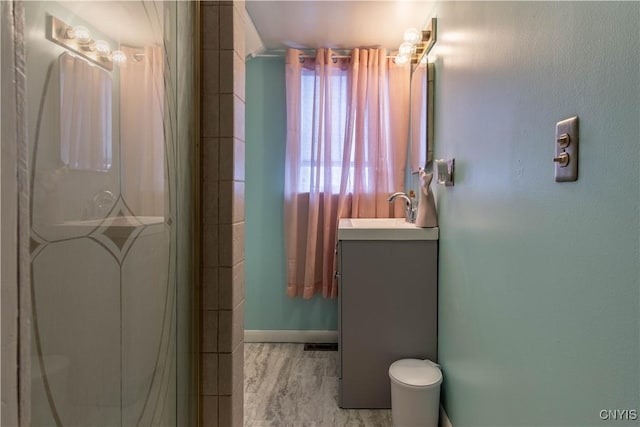 bathroom featuring vanity, an enclosed shower, and hardwood / wood-style floors