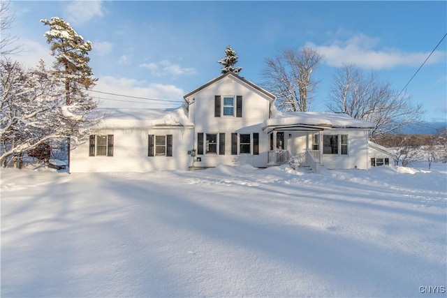 view of snow covered back of property