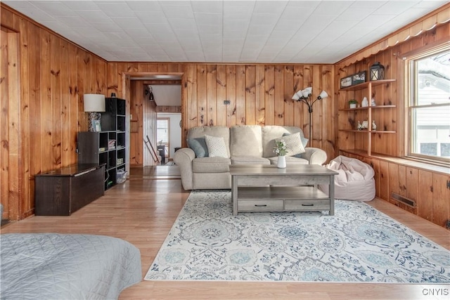 living room featuring hardwood / wood-style floors and wood walls