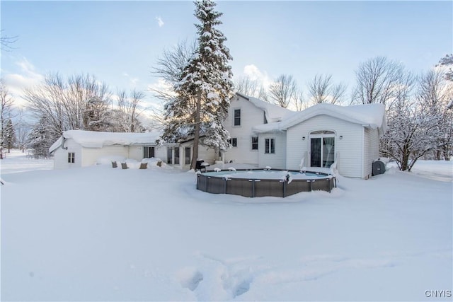 view of snow covered rear of property