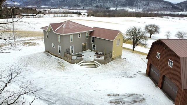 snowy aerial view with a mountain view