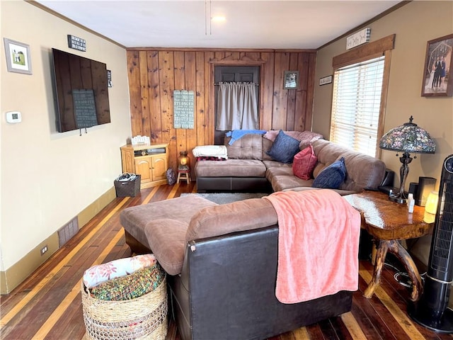 living room featuring crown molding, wooden walls, and dark hardwood / wood-style flooring