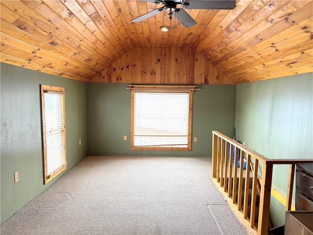 additional living space featuring lofted ceiling, a wealth of natural light, light carpet, and wooden ceiling