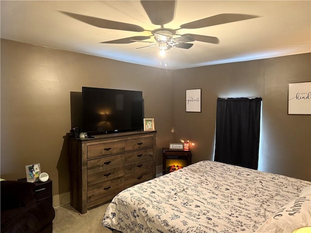 bedroom with light carpet and ceiling fan