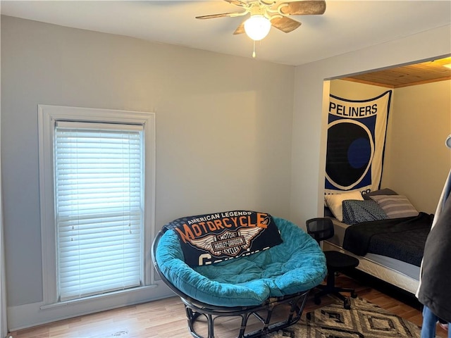 bedroom with ceiling fan, multiple windows, and light wood-type flooring