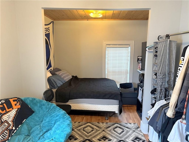 bedroom featuring wood-type flooring and wood ceiling