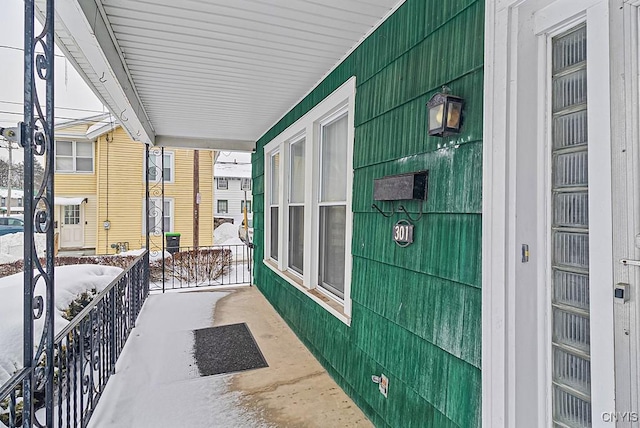 view of snow covered back of property