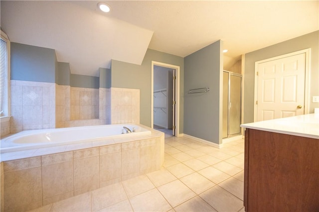 bathroom featuring tile patterned flooring, vanity, and separate shower and tub