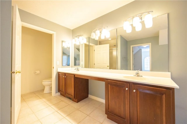 bathroom featuring vanity, toilet, a shower with door, and tile patterned flooring