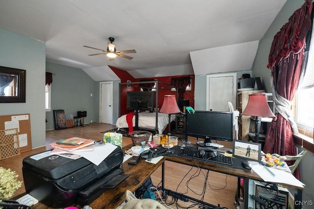 home office featuring lofted ceiling, hardwood / wood-style flooring, and ceiling fan