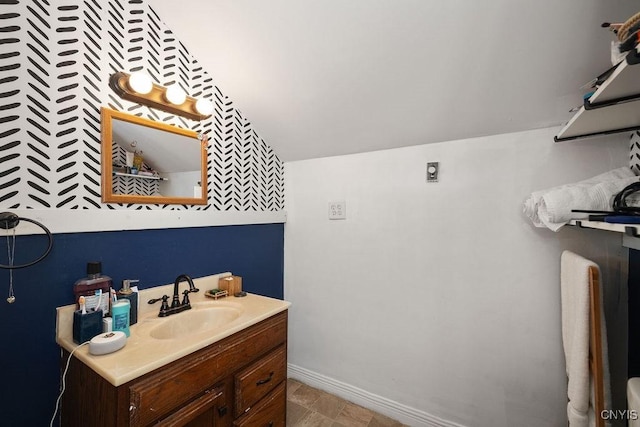 bathroom featuring vanity and lofted ceiling