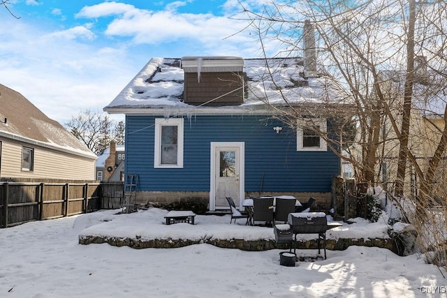 view of snow covered rear of property