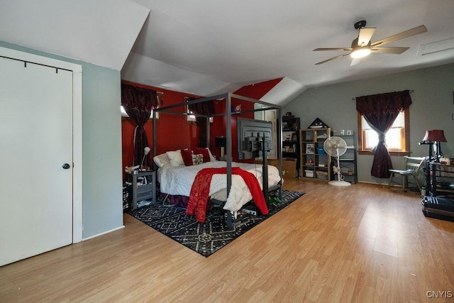 bedroom with hardwood / wood-style floors and vaulted ceiling