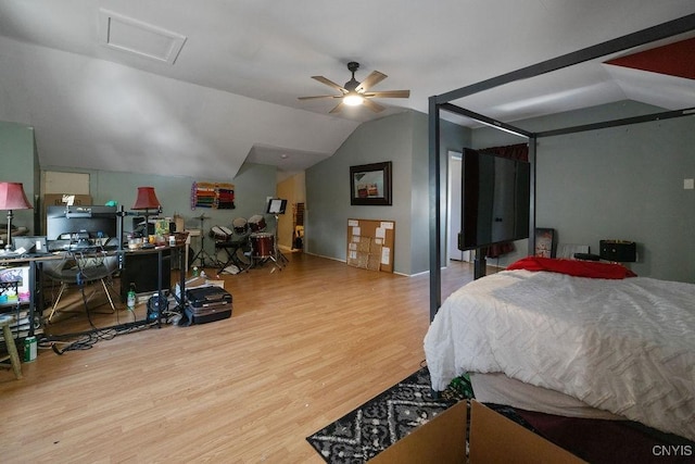 bedroom with vaulted ceiling and light hardwood / wood-style floors