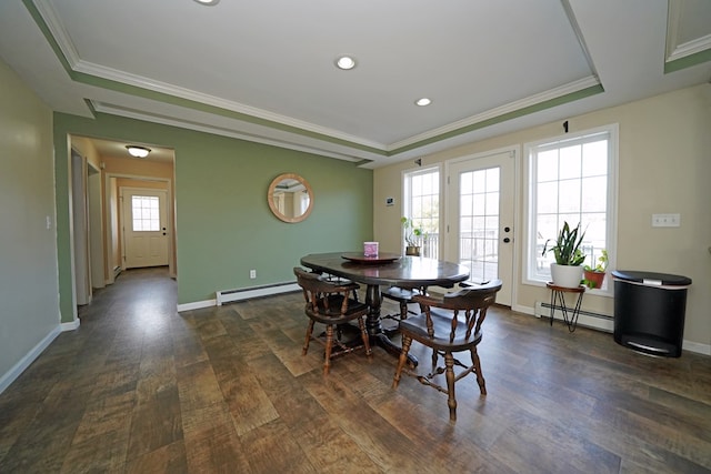 dining area with dark hardwood / wood-style flooring, a tray ceiling, and a baseboard radiator