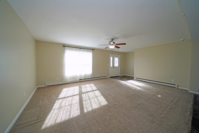 spare room with baseboard heating, light colored carpet, and ceiling fan