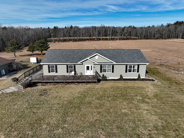 view of front facade featuring a front yard and a deck