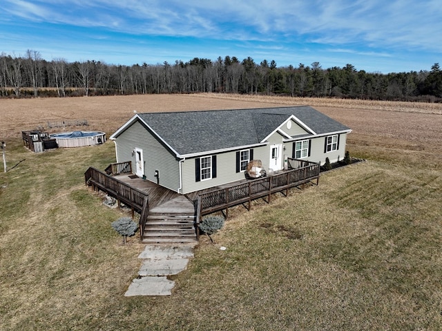 view of front of house with a swimming pool side deck and a front lawn