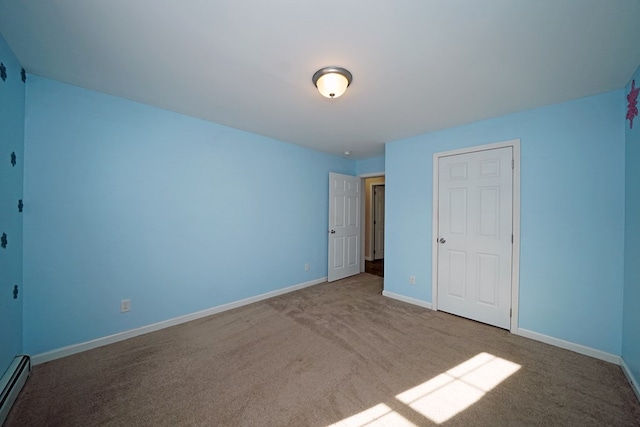 unfurnished bedroom with a baseboard radiator and carpet flooring