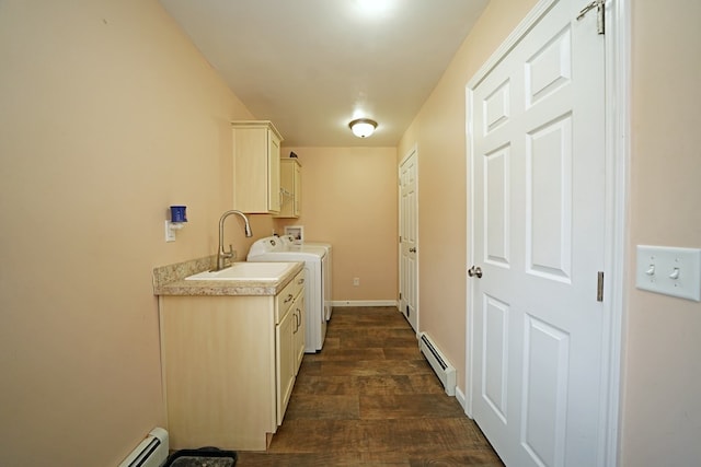 laundry area with washer / dryer, sink, cabinets, a baseboard radiator, and dark hardwood / wood-style flooring