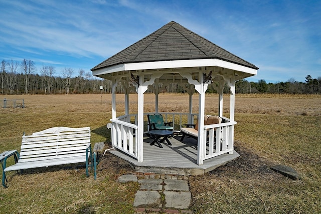 wooden terrace with a gazebo and a lawn