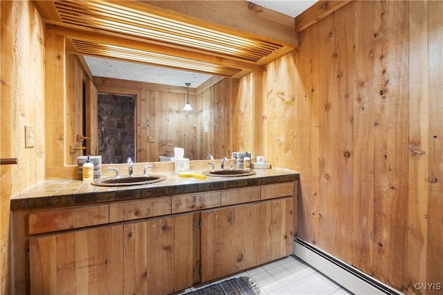 bathroom featuring vanity, a baseboard heating unit, and wooden walls