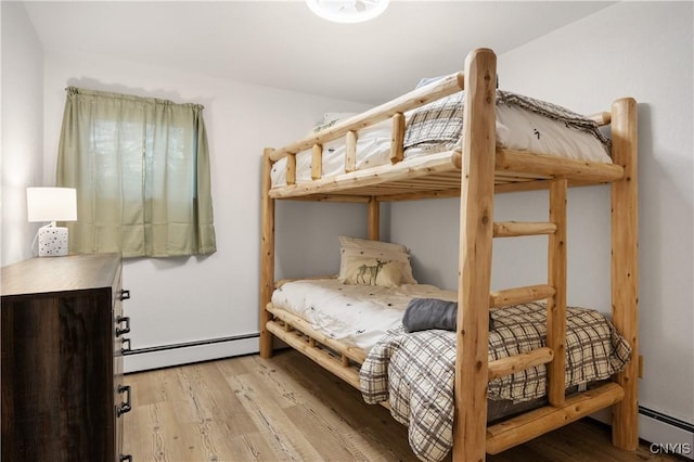 bedroom featuring light hardwood / wood-style floors and baseboard heating