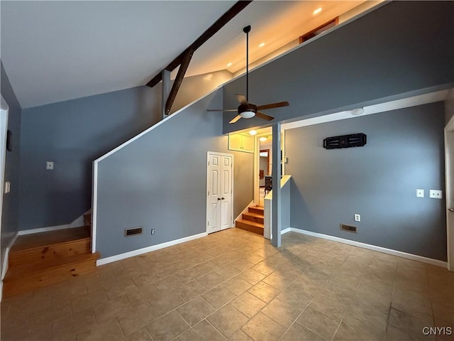 unfurnished living room with ceiling fan and high vaulted ceiling