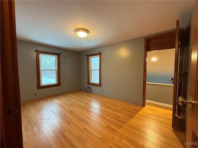 spare room with light hardwood / wood-style floors