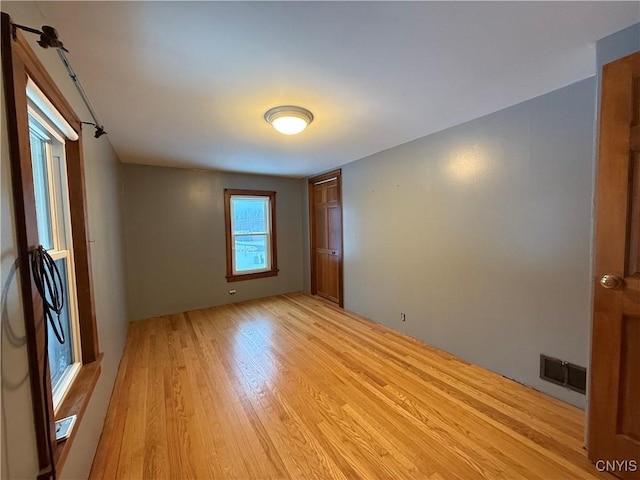 spare room with light hardwood / wood-style floors