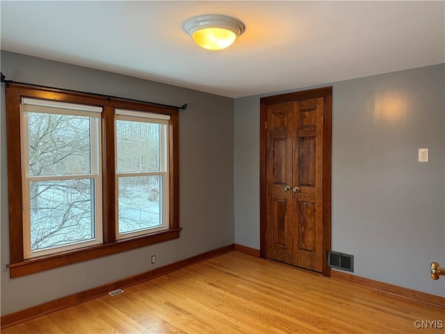 spare room with light wood-type flooring